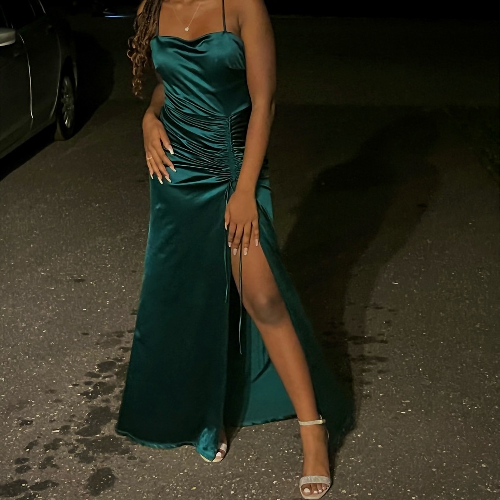 A emerald green dress with a side slit